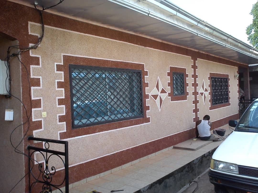 Weather-resistant granite granule coating protecting an exterior wall from rain